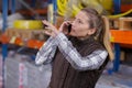 woman using phone in distribution warehouse