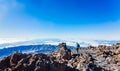 Woman using phone on the top of Teide volcano Royalty Free Stock Photo