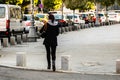 Woman using phone while walking in downtown Bucharest, Romania, 2019