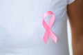 Woman using pink ribbon to support breast cancer cause or AIDS Royalty Free Stock Photo