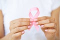 Woman using pink ribbon to support breast cancer cause or AIDS Royalty Free Stock Photo