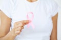 Woman using pink ribbon to support breast cancer cause or AIDS Royalty Free Stock Photo