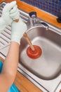 Woman using plunger Royalty Free Stock Photo