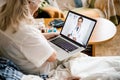 Woman using portable computer in bed Royalty Free Stock Photo