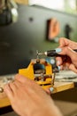 Woman using power working grinder machine, female hand grinds a metal nuts