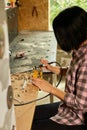 Woman using power working grinder machine, female hand grinds a metal nuts