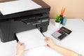 Woman using the printer to scanning and printing document