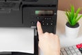 Woman using the printer to scanning and printing document