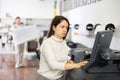 Woman using printer while working in print shop