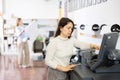 Woman using printer while working in print shop Royalty Free Stock Photo