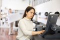 Woman using printer while working in print shop