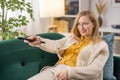 Woman using remote control for TV Royalty Free Stock Photo