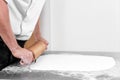 Woman using rolling pin preparing royal icing for cake decorating, hands detail. Royalty Free Stock Photo