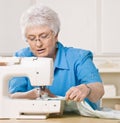 Woman using sewing machine at home Royalty Free Stock Photo