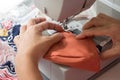 Woman using the sewing machine to making the fabric mask