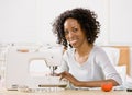 Woman using sewing machine to sew clothing Royalty Free Stock Photo