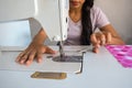 Woman using the sewing machine while working in the tailor`s shop Royalty Free Stock Photo