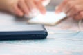 Woman using smart phone while charging on the power bank. Royalty Free Stock Photo