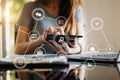 Woman using smart phone for mobile payments online shopping,omni channel,sitting on table,virtual icons graphics interface screen Royalty Free Stock Photo