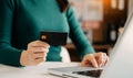 Woman using smart phone for mobile payments online shopping,omni channel,sitting on table,virtual icons graphics interface screen Royalty Free Stock Photo