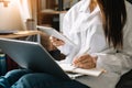 Woman using smart phone for mobile payments online shopping,omni channel,sitting on table,virtual icons graphics interface screen Royalty Free Stock Photo