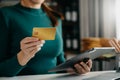 Woman using smart phone for mobile payments online shopping,omni channel,sitting on table,virtual icons graphics interface screen Royalty Free Stock Photo