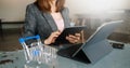 Woman using smart phone for mobile payments online shopping,omni channel,sitting on table,virtual icons graphics interface screen Royalty Free Stock Photo