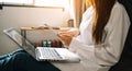 Woman using smart phone for mobile payments online shopping,omni channel,sitting on table,virtual icons graphics interface screen Royalty Free Stock Photo