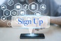 Woman using smart phone pressing button sign up icon.