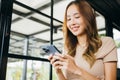 woman using smart phone for shopping online at cafe coffee shop in the morning Royalty Free Stock Photo