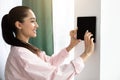Woman using smart wall home control system Royalty Free Stock Photo