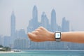 Woman using smart watch music application on beach