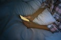 Woman using smartphone in bed at night, closeup. Nomophobia and sleeping disorder problem Royalty Free Stock Photo