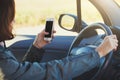 Woman using smartphone while driving a car Royalty Free Stock Photo