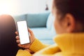 Woman using smartphone frameless mockup blank screen in home interior. Working from home concept