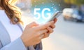 Woman using smartphone with 5G network system outdoors, closeup. Royalty Free Stock Photo