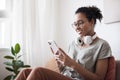 Woman using smartphone at home. Student girl texting on mobile phone in her room. Royalty Free Stock Photo