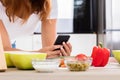 Woman Using Smartphone In Kitchen Royalty Free Stock Photo