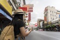 A woman using a smartphone navigation app on the road during the day. All on mobile screens are designed, check map to travel with