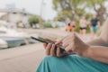 Woman using smartphone outdoors in the park, close up of female hands with mobile phone Royalty Free Stock Photo