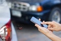 Woman using smartphone at roadside after traffic accident Royalty Free Stock Photo