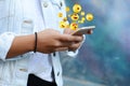 Woman using smartphone sending emojis.