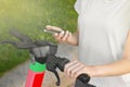 Woman using smartphone to pay and unblock electric kick scooter outdoors, closeup Royalty Free Stock Photo