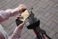 Woman using smartphone to pay and unblock electric kick scooter outdoors, closeup