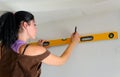 Woman using a spirit level while renovating