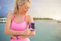 Woman using sports tracking mobile app on her smartphone