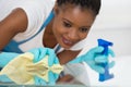 Woman Using Spray To Wipe Glass Desk Royalty Free Stock Photo