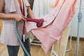 Woman using steaming iron to ironing fashion shirt in laundry room. Girl doing stream vapor iron for press clothes in hand. Royalty Free Stock Photo