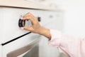 Woman using stove cooking food in kitchen Royalty Free Stock Photo