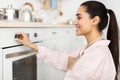 Woman using stove cooking food in kitchen Royalty Free Stock Photo